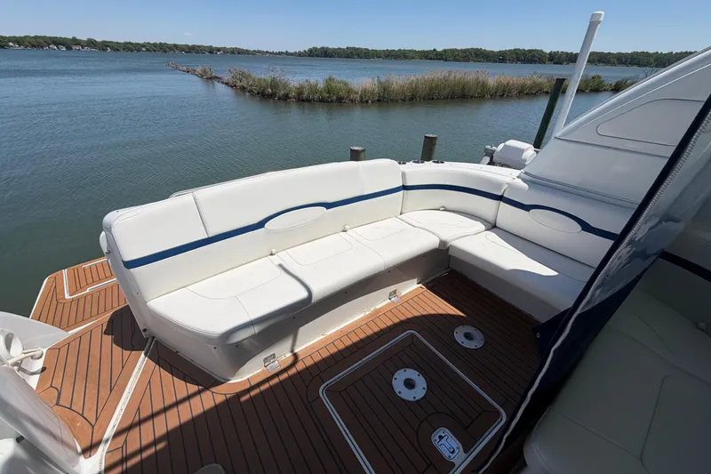 Slide: The Image of 2011 Formula 45 Yacht with white seating, wooden deck, and scenic water view. - 20