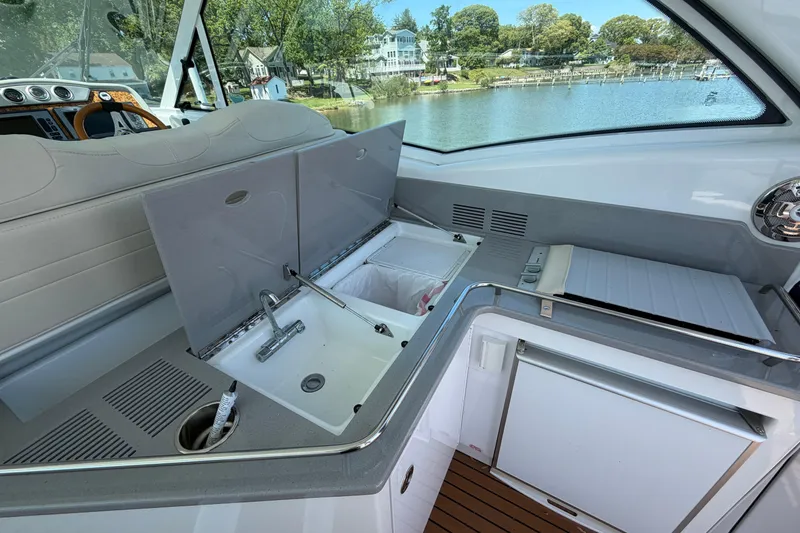 Slide: The Image of Interior view of 2011 Formula 45 Yacht featuring a sleek kitchenette with sink and storage. - 21