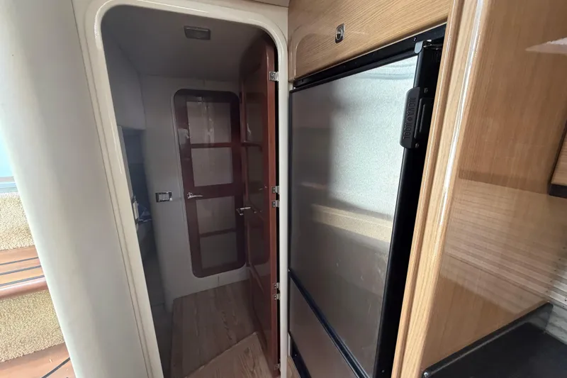 Slide: The Image of Interior of 2011 Formula 45 Yacht showing wooden cabinetry and a closed door. - 24