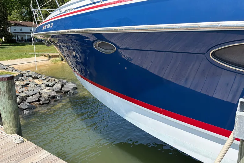 Slide: The Image of 2011 Formula 45 Yacht docked, showcasing sleek blue hull and red accents. - 25