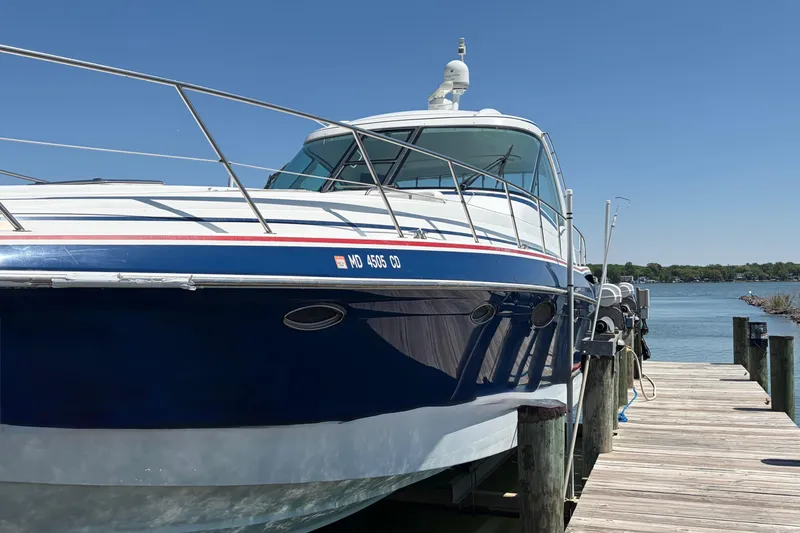 Slide: The Image of 2011 Formula 45 Yacht docked by a wooden pier on a sunny day. - 3