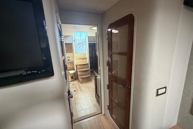 Slide: The Image of Interior view of a 2011 Formula 45 Yacht, featuring a hallway and wooden door. - 33