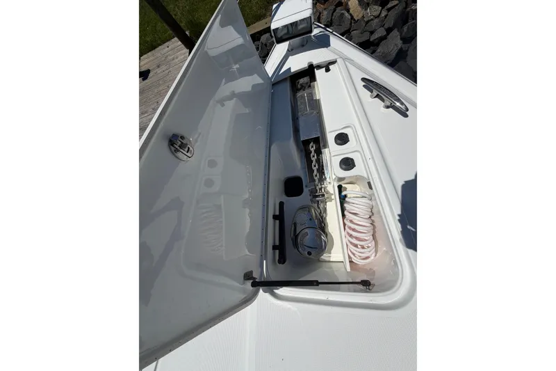 Slide: The Image of Open storage compartment on 2011 Formula 45 Yacht, featuring coiled hose and anchor chain. - 40