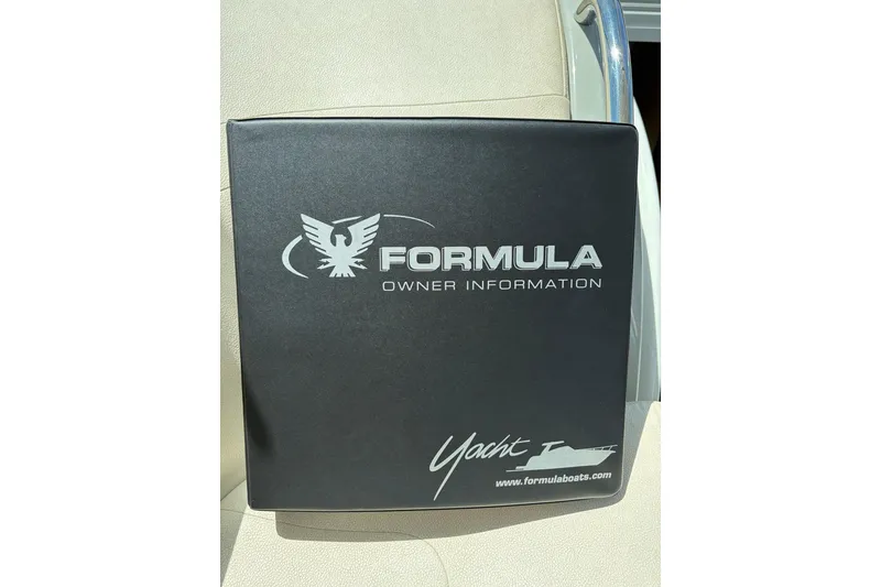 Slide: The Image of Owner information binder for 2011 Formula 45 Yacht on beige seat. - 44