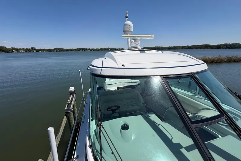 Slide: The Image of 2011 Formula 45 Yacht docked on a serene lake under a clear blue sky. - 5