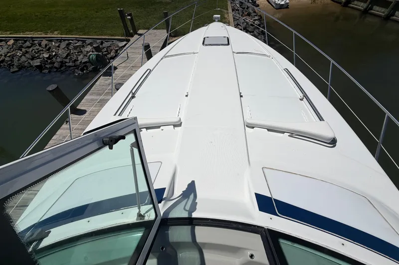 Slide: The Image of 2011 Formula 45 Yacht docked, view from the deck, showcasing sleek design and marina surroundings. - 6