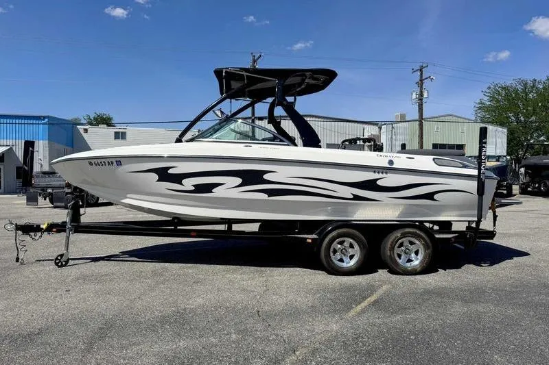 The Image of 2007 Centurion Enzo SV216 boat on trailer, featuring sleek black and white design. - 0