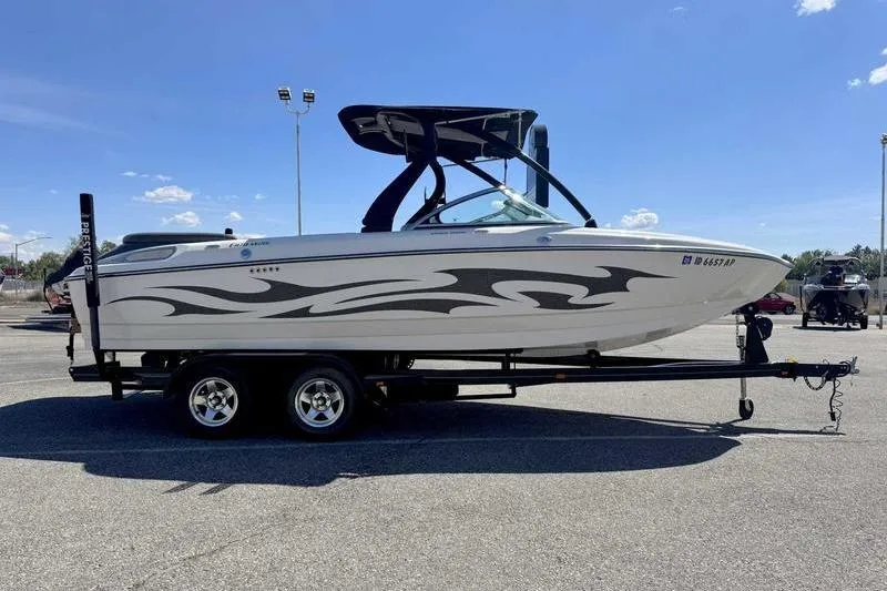 Slide: The Image of 2007 Centurion Enzo SV216 boat on trailer, featuring sleek design and graphics. - 11