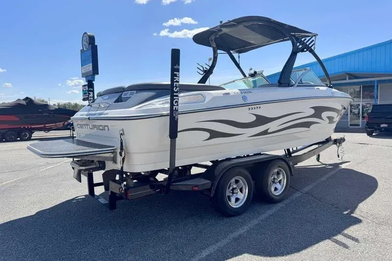 Slide: The Image of 2007 Centurion Enzo SV216 boat on trailer, parked outdoors under clear sky. - 12