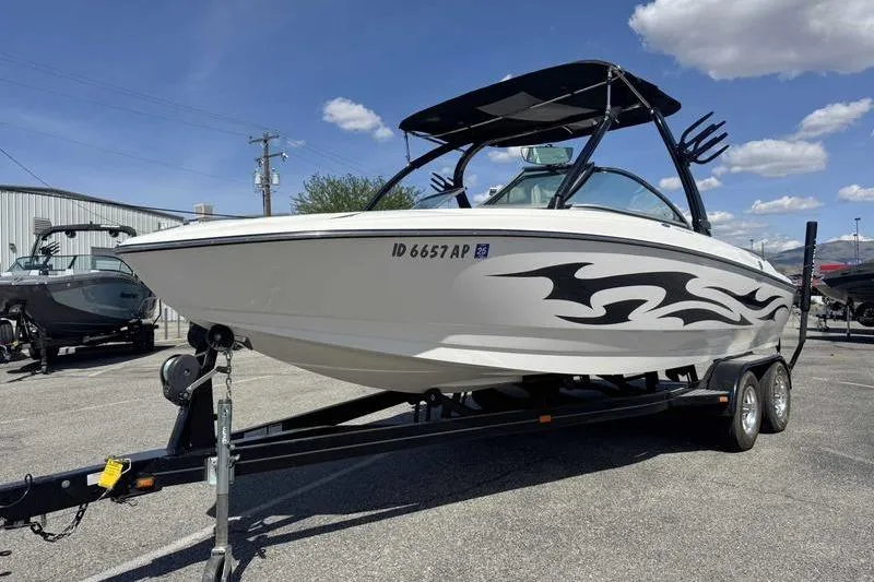 Slide: The Image of 2007 Centurion Enzo SV216 boat on trailer with custom graphics under blue sky. - 14