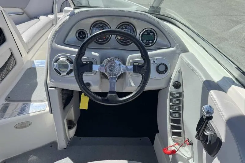Slide: The Image of 2007 Centurion Enzo SV216 boat dashboard with steering wheel and control panel. - 5