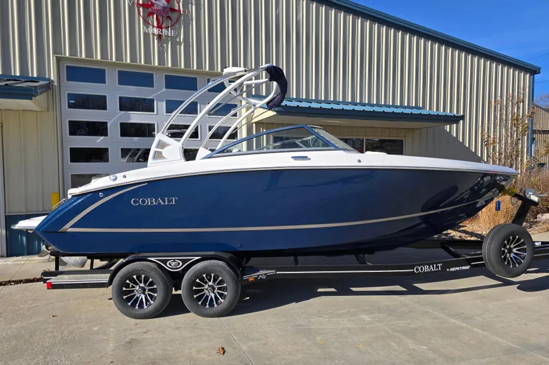 Slide: The Image of 2020 Cobalt R3 boat on trailer, parked outside a metal building. - 7