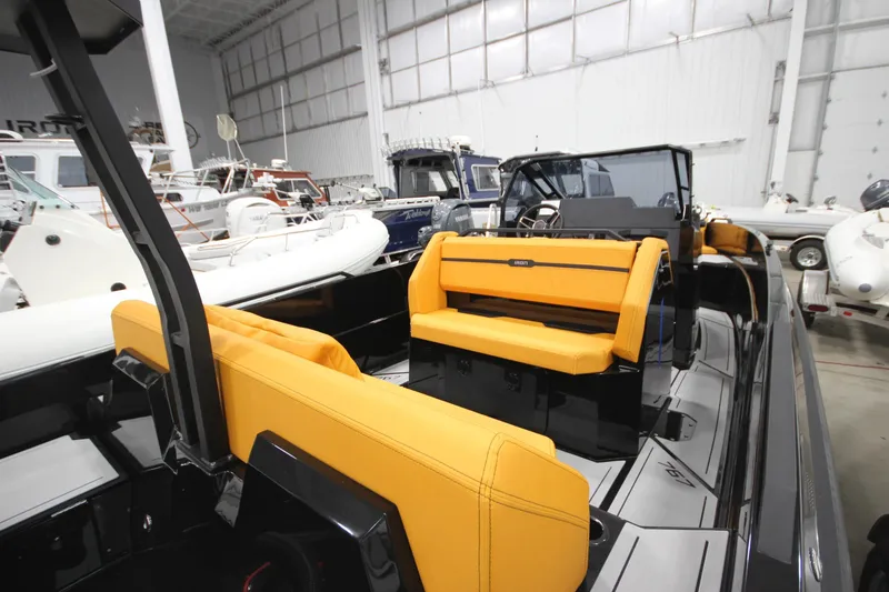 Slide: The Image of 2026 Iron 767 boat interior with vibrant orange seating in a showroom. - 10