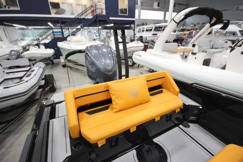 Slide: The Image of Showroom display of Iron 767 boat, featuring vibrant orange seating and sleek design, 2026 model. - 13