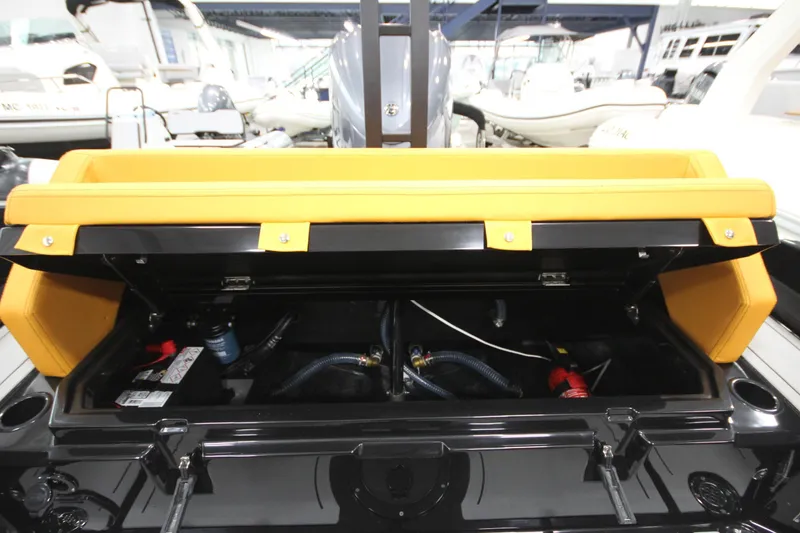 Slide: The Image of Open storage compartment of Iron 767 boat, showcasing internal components and yellow seating. - 14