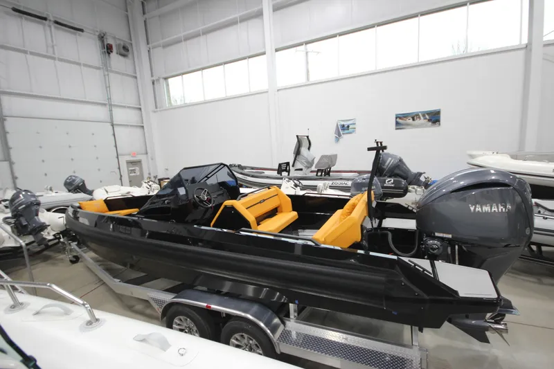 Slide: The Image of Modern Iron 767 boat with Yamaha engine, showcased indoors, featuring sleek design and vibrant seating. - 2