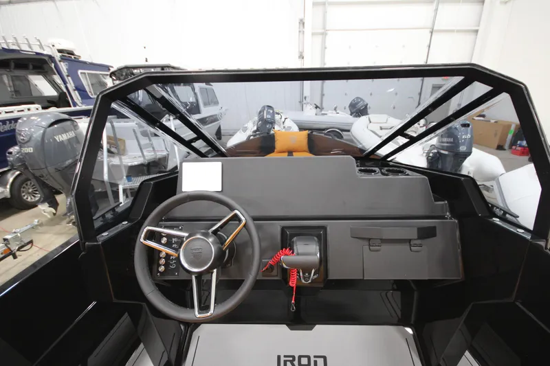 Slide: The Image of Interior view of Iron 767 boat dashboard, featuring steering wheel and controls, 2026 model. - 21