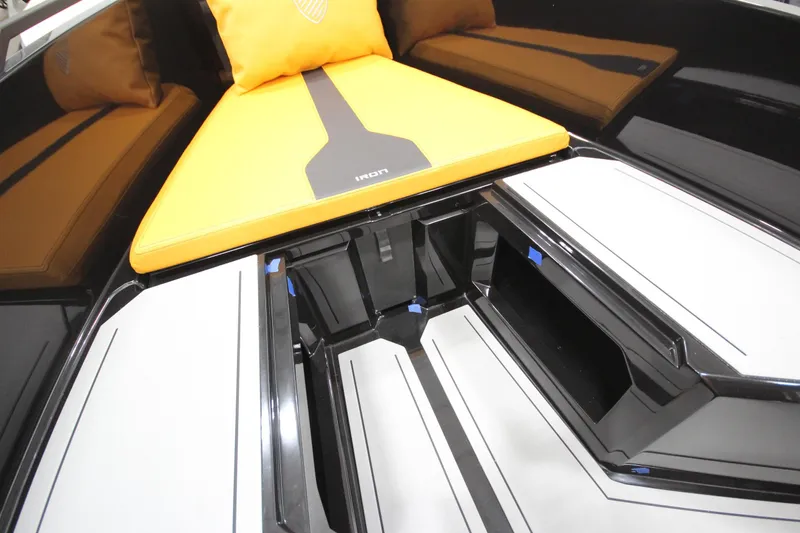 Slide: The Image of Interior of 2026 Iron 767 boat with sleek design and vibrant orange cushion. - 22
