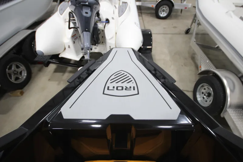Slide: The Image of Iron 767 boat, 2026 model, displayed in a showroom with trailers. - 29