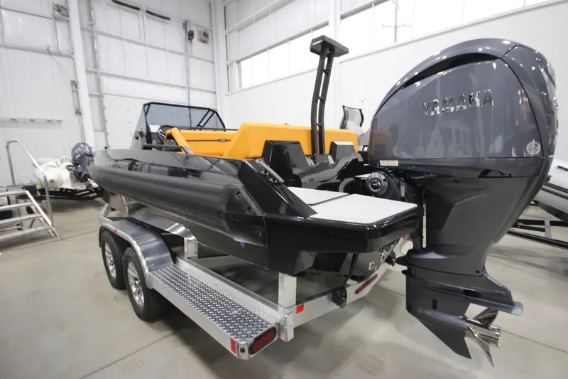 Slide: The Image of Modern Iron 767 boat with Yamaha engine on trailer in indoor showroom. - 5