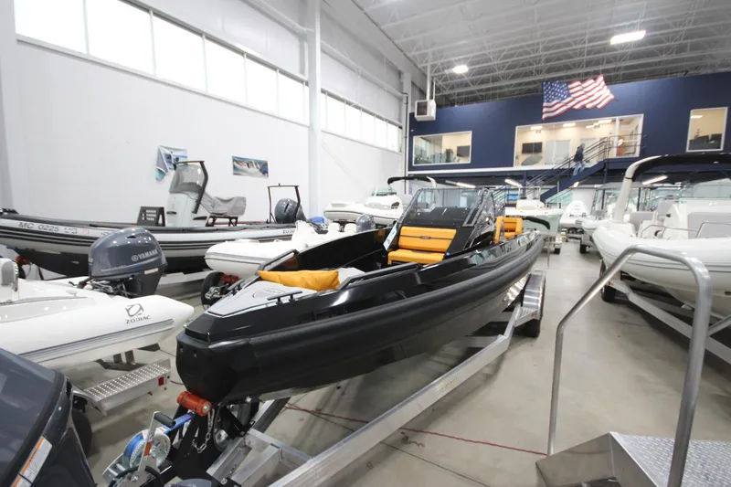 Slide: The Image of 2026 Iron 767 boat displayed in a showroom with other vessels. - 6