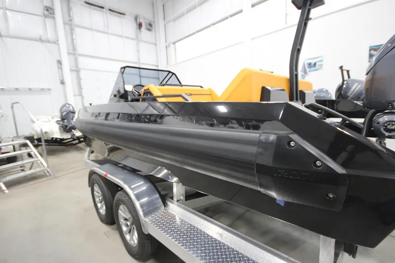 Slide: The Image of 2026 Iron 767 boat on trailer in indoor showroom. - 7