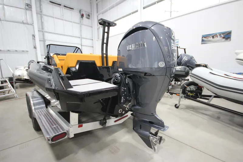 Slide: The Image of 2026 Iron 767 boat with Yamaha outboard motor on trailer in showroom. - 8
