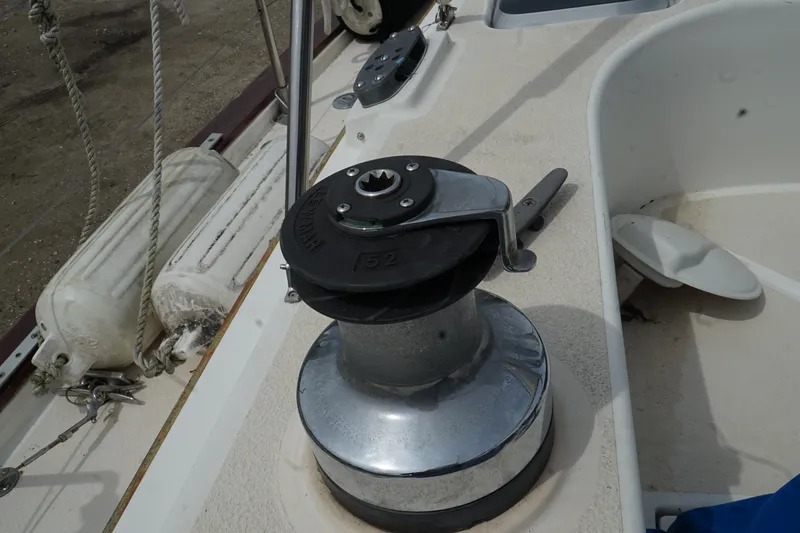 Slide: The Image of Winch on 1987 Morgan 43 sailboat deck with ropes and fenders. - 10