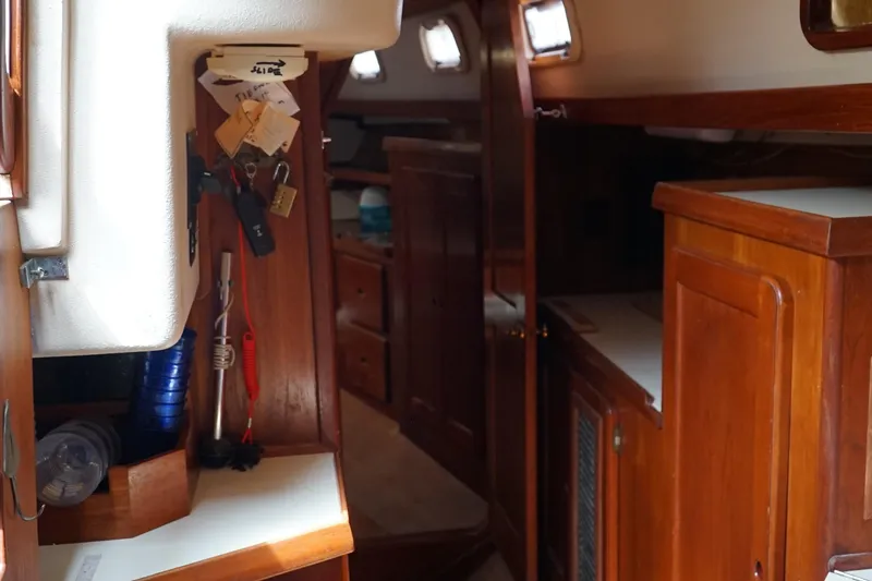 Slide: The Image of Interior of a 1987 Morgan 43 sailboat with wooden cabinetry and nautical decor. - 19
