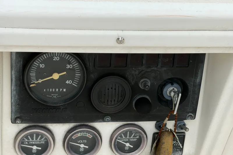Slide: The Image of Dashboard of a 1987 Morgan 43 boat with gauges and ignition key. - 22