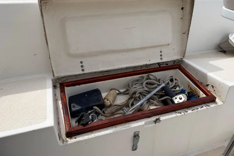 Slide: The Image of Open storage compartment on 1987 Morgan 43 boat with ropes and tools inside. - 25