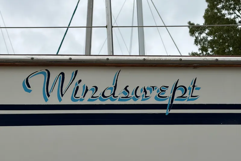 Slide: The Image of 1987 Morgan 43 sailboat with "Windswept" name on the hull. - 26
