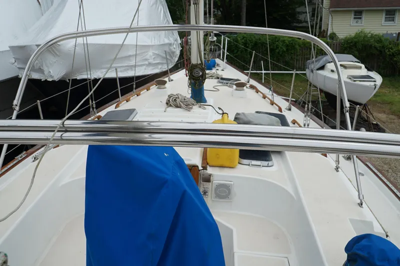 Slide: The Image of 1987 Morgan 43 sailboat deck with blue cover and nautical equipment. - 5