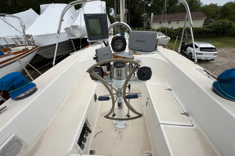 Slide: The Image of Cockpit of a 1987 Morgan 43 sailboat with navigation equipment and steering wheel. - 6