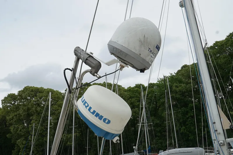 Slide: The Image of Radar equipment on a 1987 Morgan 43 sailboat, surrounded by trees and masts. - 8