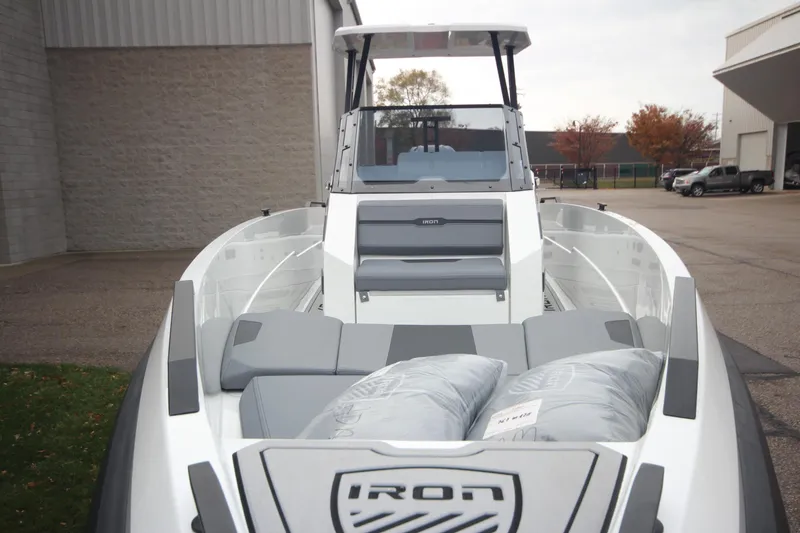Slide: The Image of 2026 Iron 767 boat with sleek design, docked outdoors near industrial buildings. - 10