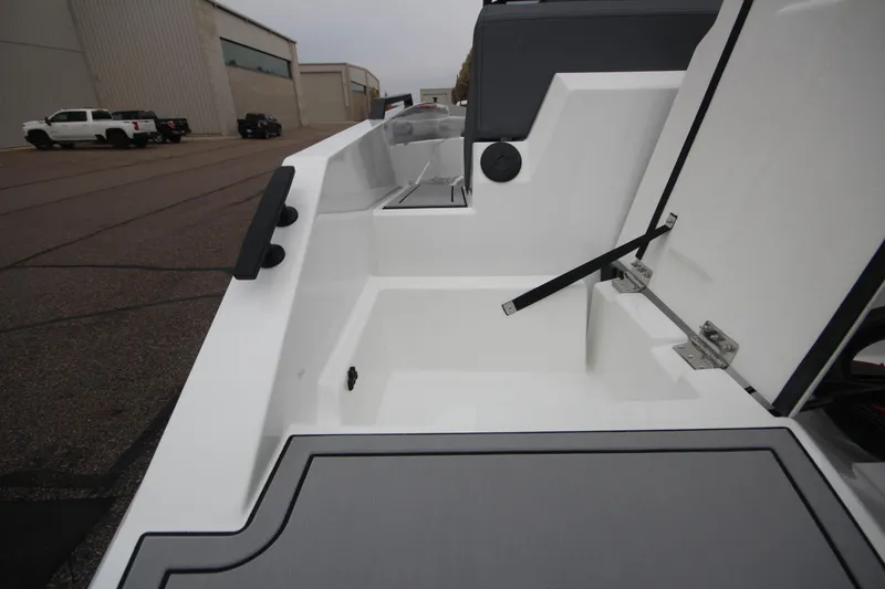 Slide: The Image of Open storage compartment on Iron 767 boat, 2026 model, parked near industrial buildings. - 12