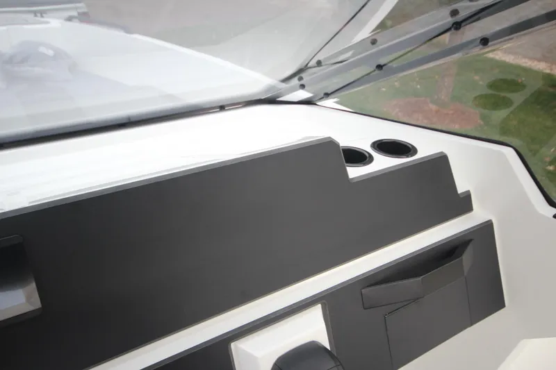 Slide: The Image of Dashboard of Iron 767 boat, featuring sleek design and cup holders, 2026 model. - 25