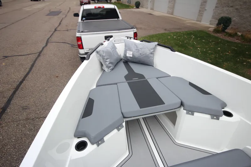 Slide: The Image of 2026 Iron 767 boat interior with gray seating, parked on a street. - 28
