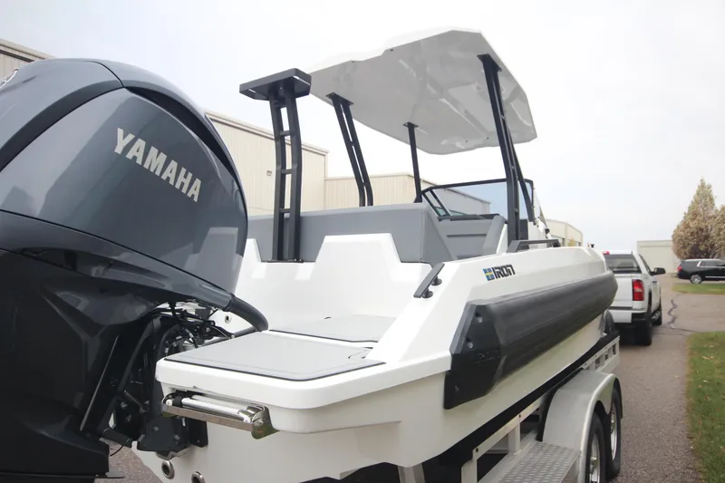 Slide: The Image of Modern Iron 767 boat with Yamaha engine, 2026 model, on a trailer in an industrial area. - 7