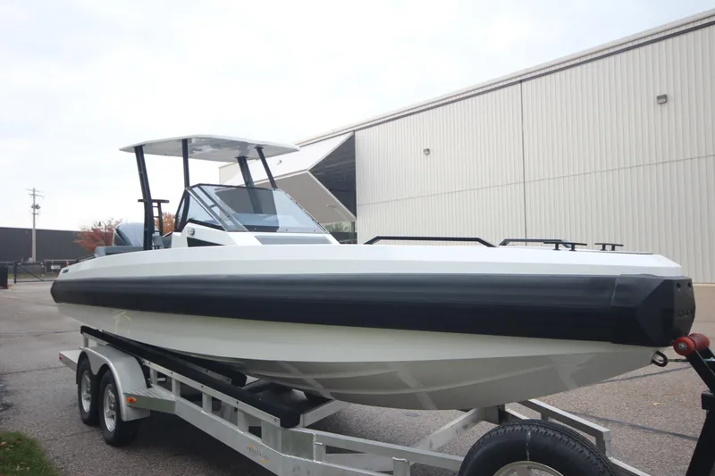 Slide: The Image of 2026 Iron 767 boat on trailer outside industrial building. - 9