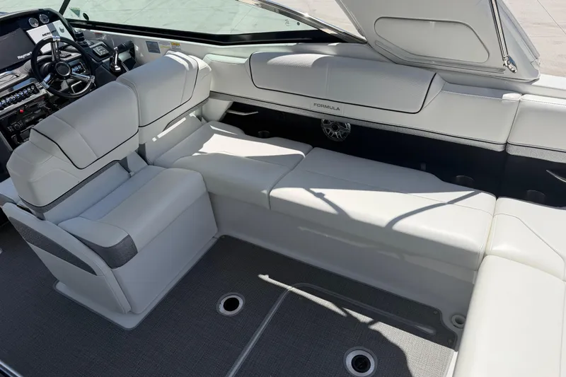 Slide: The Image of 2022 Formula 310 Sun Sport boat interior with luxurious white seating and modern dashboard. - 15