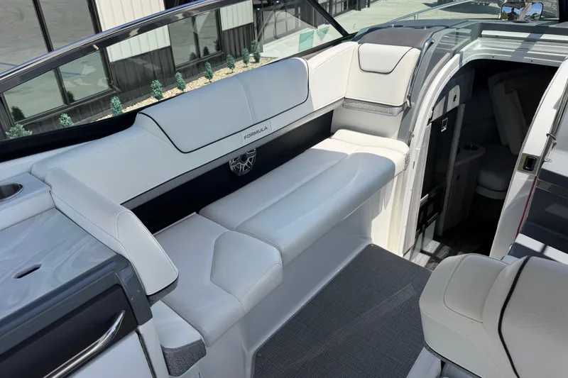 Slide: The Image of 2022 Formula 310 Sun Sport boat interior with white seating and cabin entrance. - 17