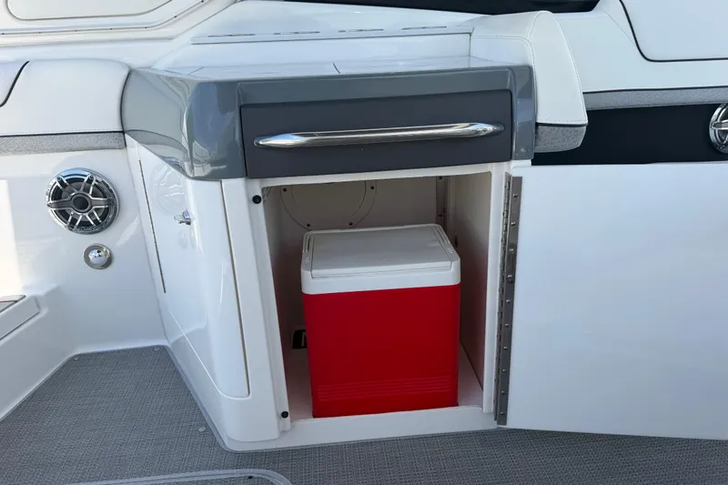 Slide: The Image of 2022 Formula 310 Sun Sport boat interior with red cooler in storage compartment. - 18