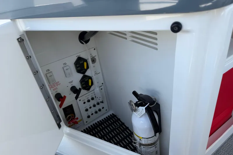 Slide: The Image of Control panel and fire extinguisher inside 2022 Formula 310 Sun Sport boat compartment. - 20