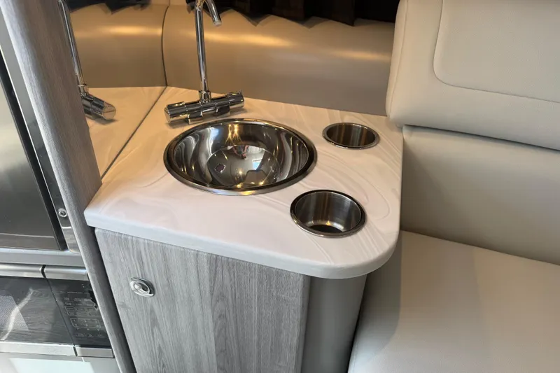 Slide: The Image of 2022 Formula 310 Sun Sport interior with sink and cup holders. - 21