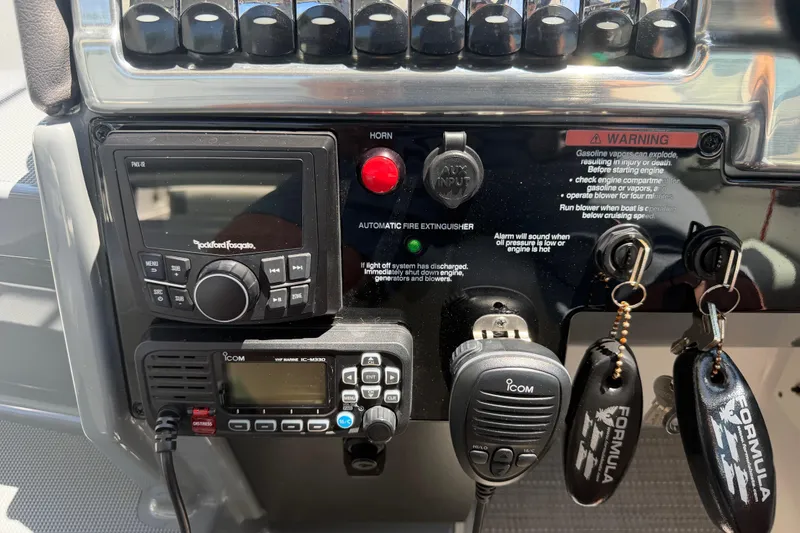 Slide: The Image of Control panel of a 2022 Formula 310 Sun Sport boat with audio and communication systems. - 26