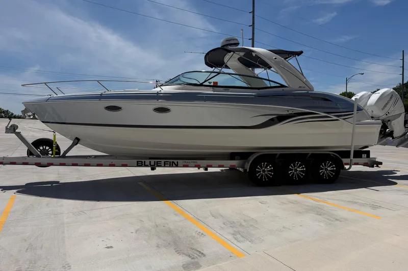 Slide: The Image of 2022 Formula 310 Sun Sport boat on Blue Fin trailer in parking lot. - 7