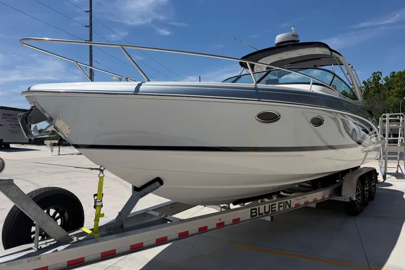 Slide: The Image of 2022 Formula 310 Sun Sport boat on trailer under clear blue sky. - 9