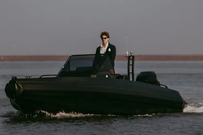 The Image of Man piloting IRON BOATS IRON 767, 2026 model, on calm water. - 1